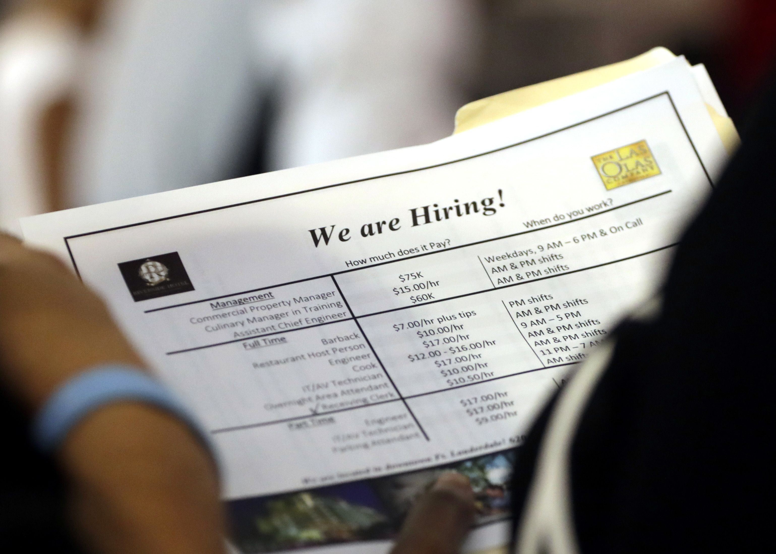 FILE In this June 21, 2018 file photo, a job applicant looks at job listings for the Riverside Hotel at a job fair hosted by Job News South Florida, in Sunrise, Fla. The U.S. unemployment rate fell to 3.7 percent in September 2018 the lowest level since December 1969 — signaling how the longest streak of hiring on record has put millions of Americans back to work. Employers added just 134,000 jobs last month, the fewest in a year, the Labor Department said Friday, Oct. 5. But that figure was likely depressed by the impact of Hurricane Florence. (AP Photo/Lynne Sladky)