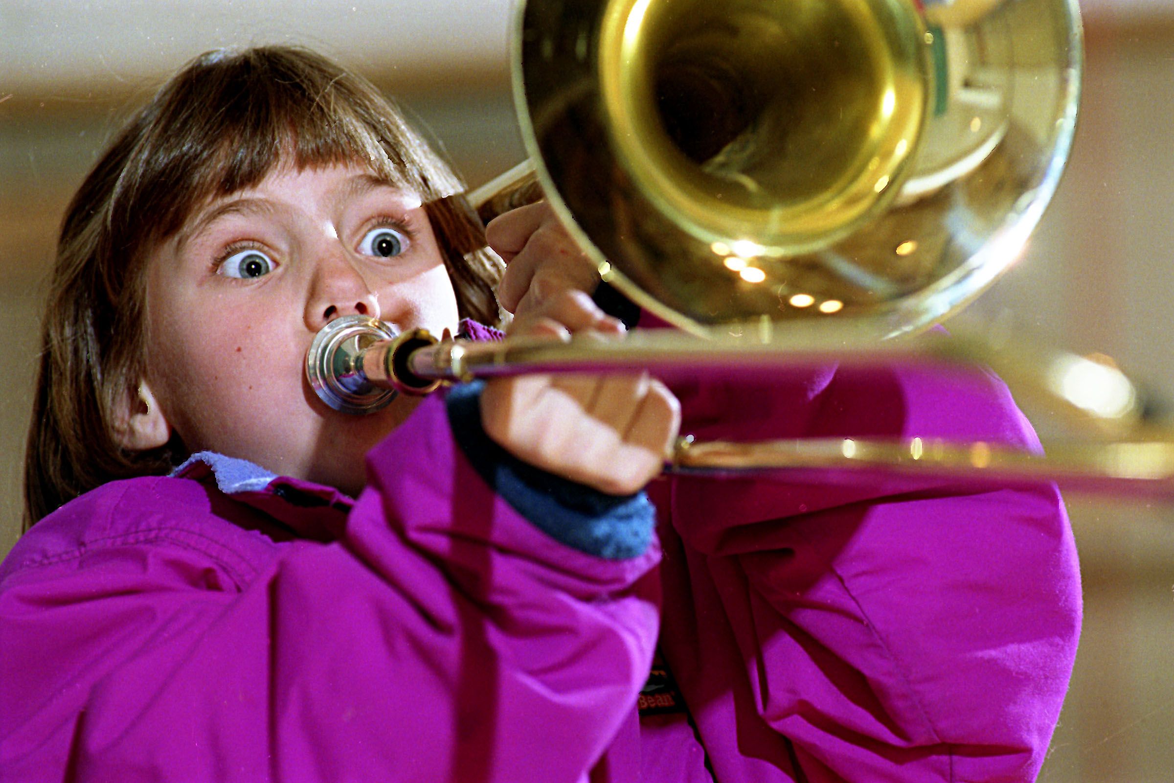 Fourth-grader Kathryn Harris, 9, tries out a trombone during a demonstration of band instruments by David Ellis of Ellis Music Co. at Marion Cross Elementary School in Norwich, Vt., on March 4, 1994. Ellis is carrying on a tradition started by his father, Richard Ellis, more than 45 years ago. (Valley News - Geoff Hansen) Copyright Valley News. May not be reprinted or used online without permission. Send requests to permission@vnews.com.