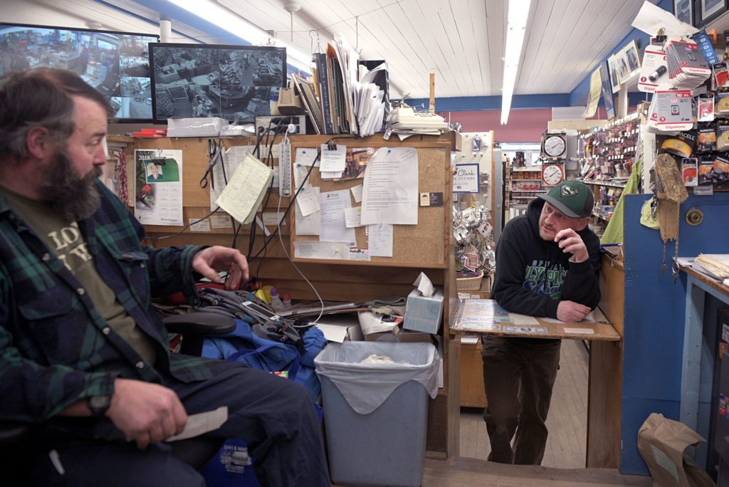 Employee Josh Picknell, of Lyndonville, Vt., right, asks co-owner Matt Fraser a question at Dan & Whit's General Store in Norwich, Vt., on Jan. 7, 2019. (Valley News - Joseph Ressler) Copyright Valley News. May not be reprinted or used online without permission. Send requests to permission@vnews.com.