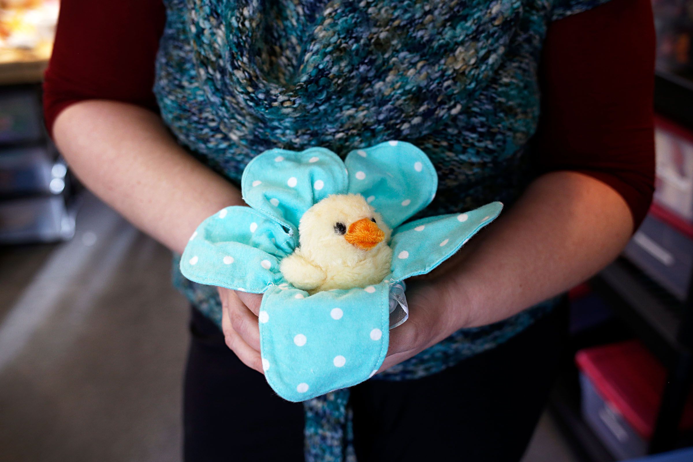 Julie Baker demonstrates a "peep pouch," which is designed to make holding baby chicks safer and easier for kids, at Pampered Poultry in Claremont, N.H., on Jan. 10, 2019.  (Valley News - Joseph Ressler) Copyright Valley News. May not be reprinted or used online without permission. Send requests to permission@vnews.com.
