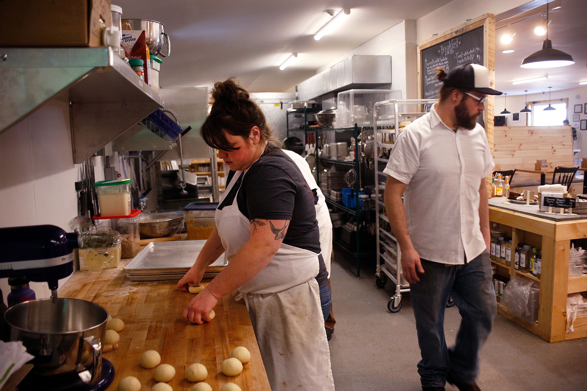 Head baker Laura Horner-Richardson, of Brownsville, makes the day's doughnuts as line cook Forrest Dubuc, of Woodstock, Vt., works at the Brownsville Butcher & Pantry in Brownsville, Vt., on Jan. 17, 2019. (Valley News - Joseph Ressler) Copyright Valley News. May not be reprinted or used online without permission. Send requests to permission@vnews.com.
