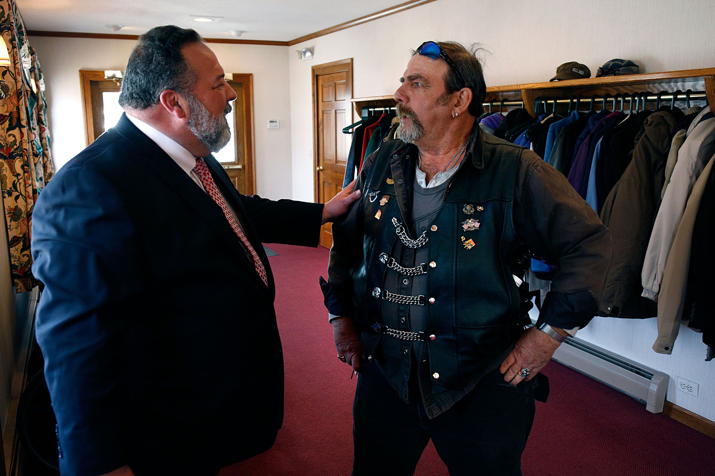 Ricker Funeral Home owner David Ahern speaks with Rodney Young, of Bradford, Vt., about the Harley Davidson motorcycle Young rode from his home to a memorial service for Fay "Woody" Woodward in Lebanon, N.H., on April 2, 2019. Young said it was 34 degrees when he hit the road to be part of a tribute for Woodward, who was a member of the Upper Valley chapter of the Harley Owners Group. (Valley News - Geoff Hansen) Copyright Valley News. May not be reprinted or used online without permission. Send requests to permission@vnews.com.