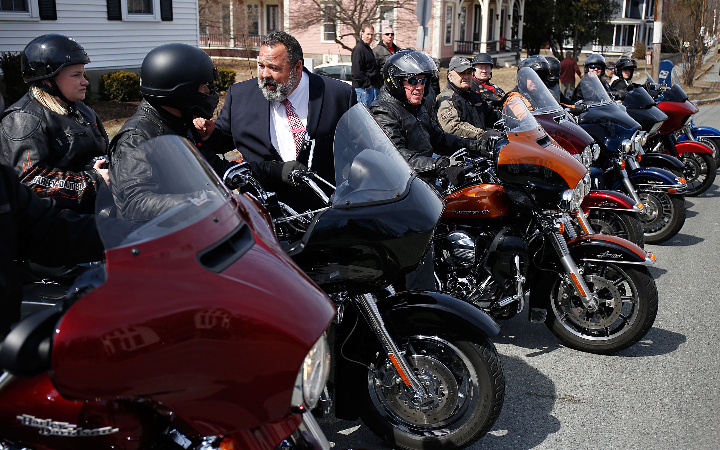 After handing off the urn with Fay "Woody" Woodward's remains, Ricker Funeral Home owner David Ahern speaks with Woodward's granddaughter Ashlee Delisle, of Plainfield, N.H., and brother-in-law John Andress, also of Plainfield, who are riding to the cemetery with fellow members of the Upper Valley chapter of the Harley Owners Group. Woodward was a life-long motorcycle enthusiast. "He was able to ride up to the very end," said a family member during his service. (Valley News - Geoff Hansen) Copyright Valley News. May not be reprinted or used online without permission. Send requests to permission@vnews.com.