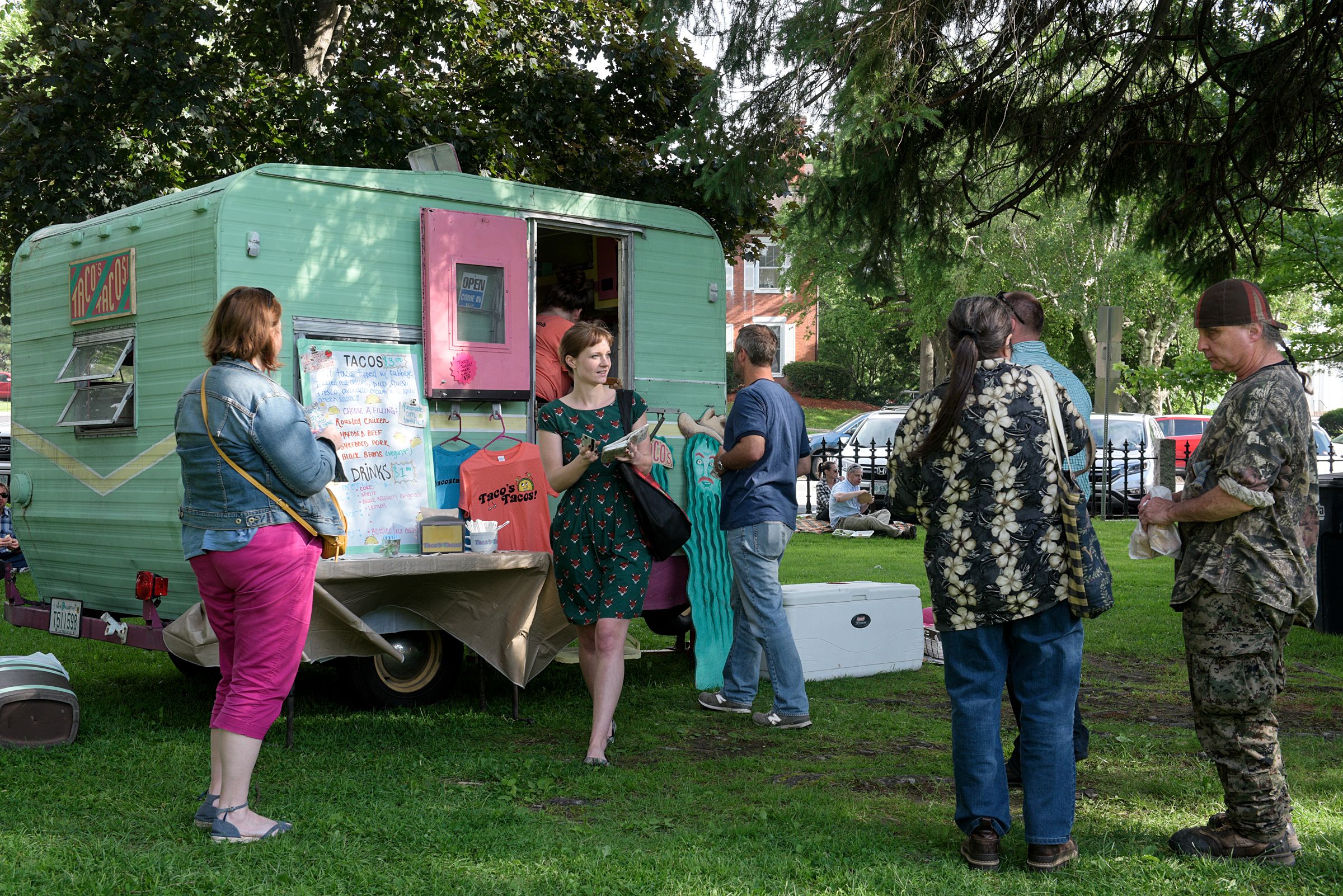 Kymberly Byerly, of Wilder, second from left, steps away from Taco's Tacos after placing her order during the Lebanon (N.H.) Food Truck Festival in Colburn Park, Friday, June 21, 2019. (Valley News - James M. Patterson) Copyright Valley News. May not be reprinted or used online without permission. Send requests to permission@vnews.com.