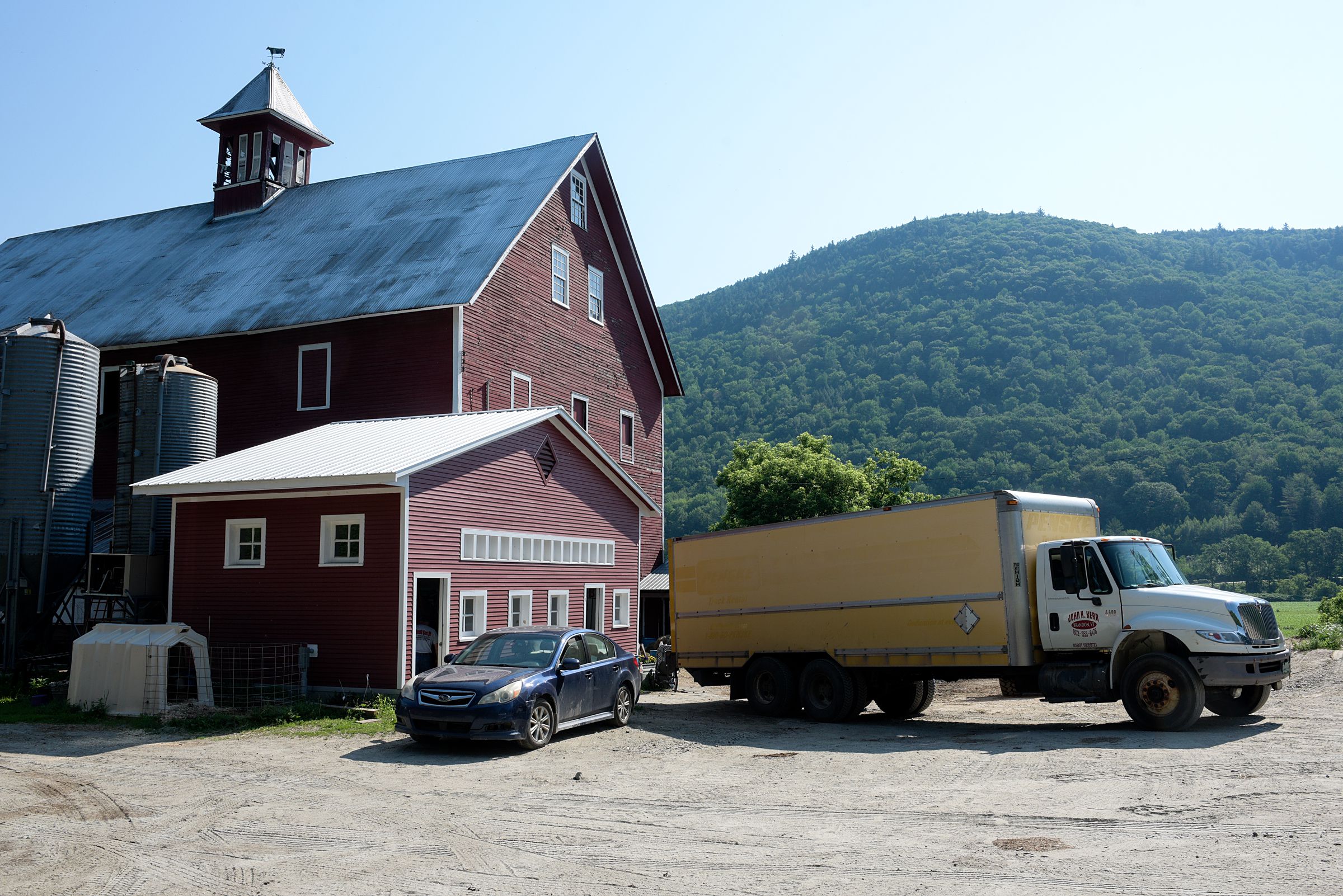 John Kerr's delivery truck is parked outside the barn at Liberty Hill Farm during a delivery in Rochester, Vt., Wednesday, July 3, 2019. "He's a great barometer of what is happening on the farm, what farms need and what the dairy industry needs," said Beth Kennett, of Liberty Hill Farm. (Valley News - James M. Patterson) Copyright Valley News. May not be reprinted or used online without permission. Send requests to permission@vnews.com.