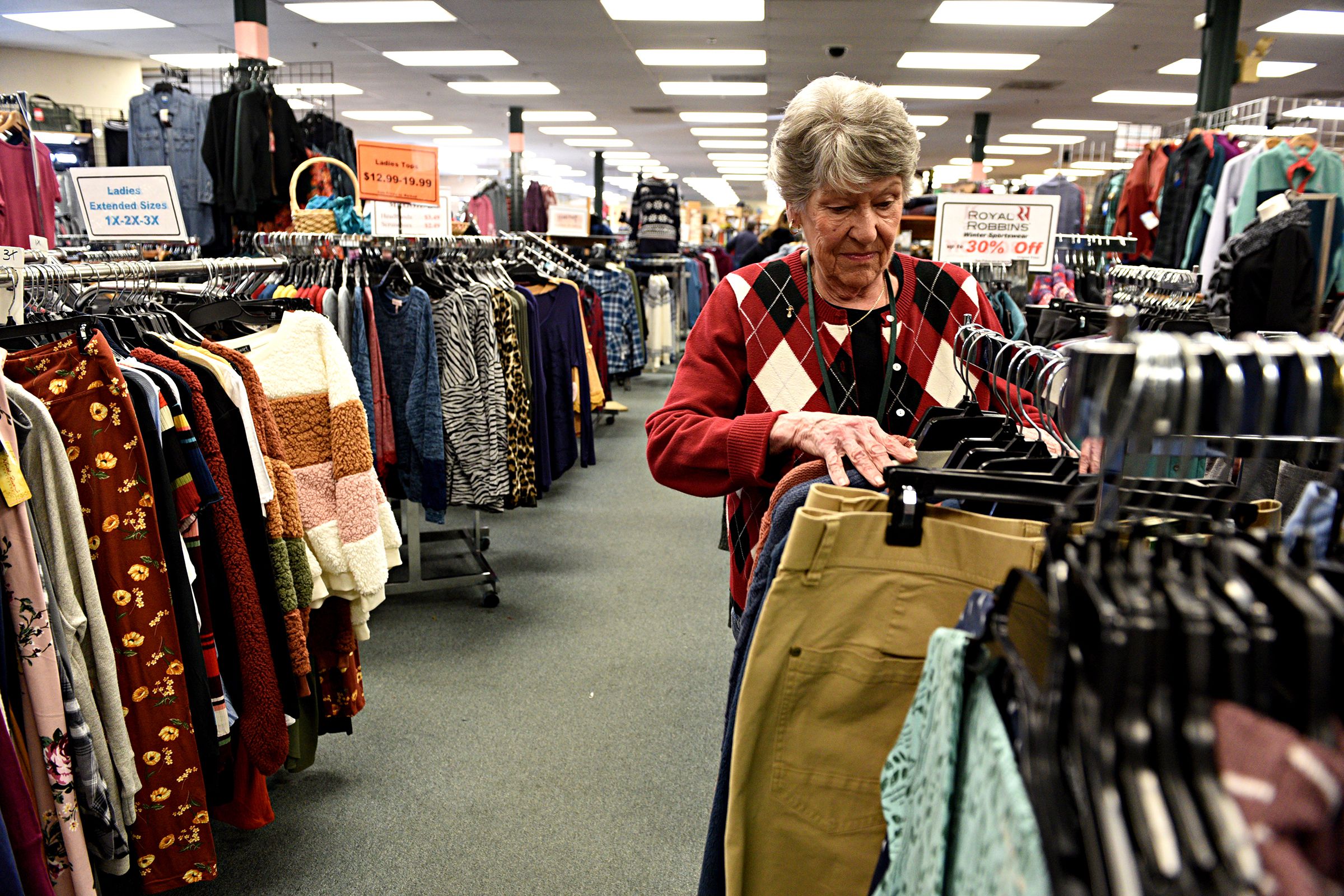 Pauline Robert organizes a clothing rack at Hubert's in Lebanon, N.H., on Saturday, Dec. 28, 2019. Robert has been working at the store for three years. (Valley News - Jennifer Hauck) Copyright Valley News. May not be reprinted or used online without permission. Send requests to permission@vnews.com.