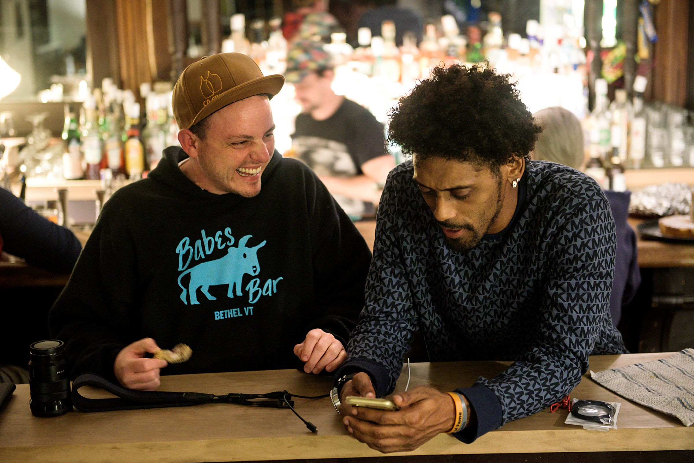 Owen Daniel-McCarter, co-owner of Babes Bar, left, talks with Tre Groves, of Braintree, right, in Bethel, Vt., Wednesday, Oct. 7, 2020. Daniel-McCarter and Jesse Plotsky, background, are working with Groves to develop a menu for a food trailer they plan to open outside the bar.  (Valley News - James M. Patterson) Copyright Valley News. May not be reprinted or used online without permission. Send requests to permission@vnews.com.
