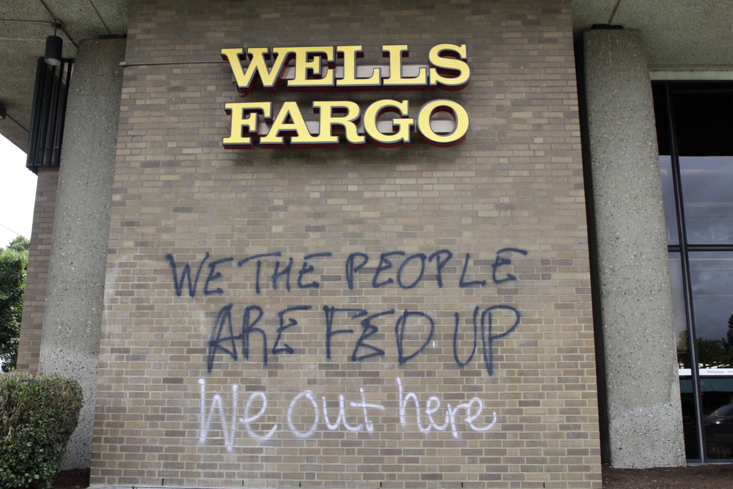 Graffiti covers the exterior of a Wells Fargo bank on Wednesday, July 1, 2020, in a historically Black neighborhood in Portland, Ore., that has been the scene of violent clashes with police in recent days. Thousands of protesters in the liberal and predominantly white city have taken to the streets peacefully every day for more than five weeks to decry police brutality, but recent violence by smaller groups is creating a deep schism in the protest movement. As demonstrations enter...