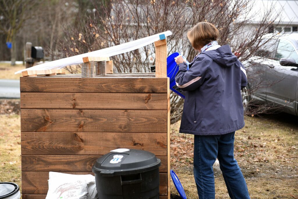 Sue Buckley, of Wilder, Vt., drops her compost off at Willow Tree Compost in Wilder on Thursday, March 25, 2021.  (Valley News - Jennifer Hauck) Copyright Valley News. May not be reprinted or used online without permission. Send requests to permission@vnews.com.