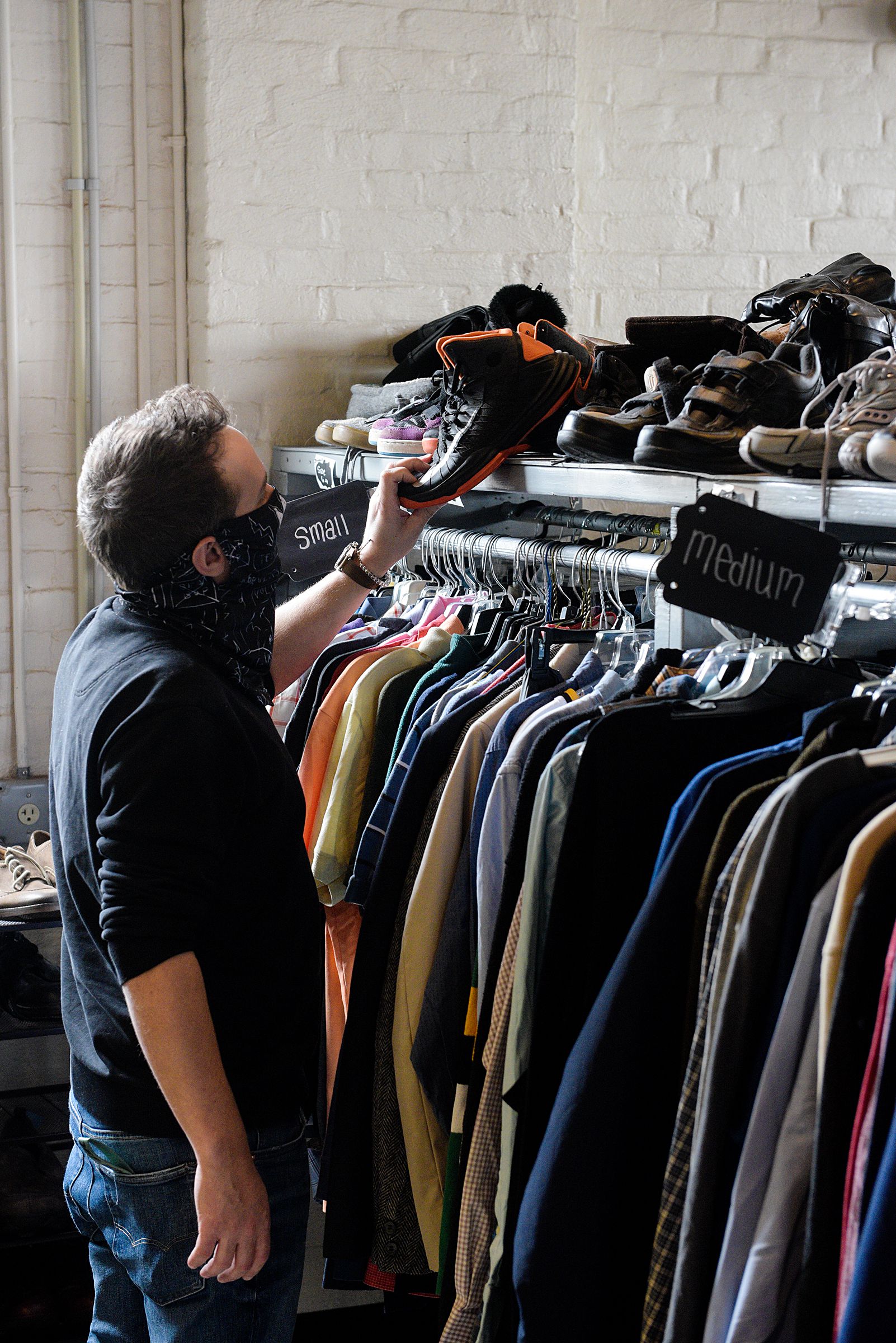 Garrett Boes, of Keene, browses the racks at Uplifting Thrifting in White River Junction, Vt., Thursday, March 25, 2021. Boes was shopping at Vermont Salvage when he caught sight of the second-hand store's sign from across the train tracks and decided to stop in. (Valley News - James M. Patterson) Copyright Valley News. May not be reprinted or used online without permission. Send requests to permission@vnews.com.