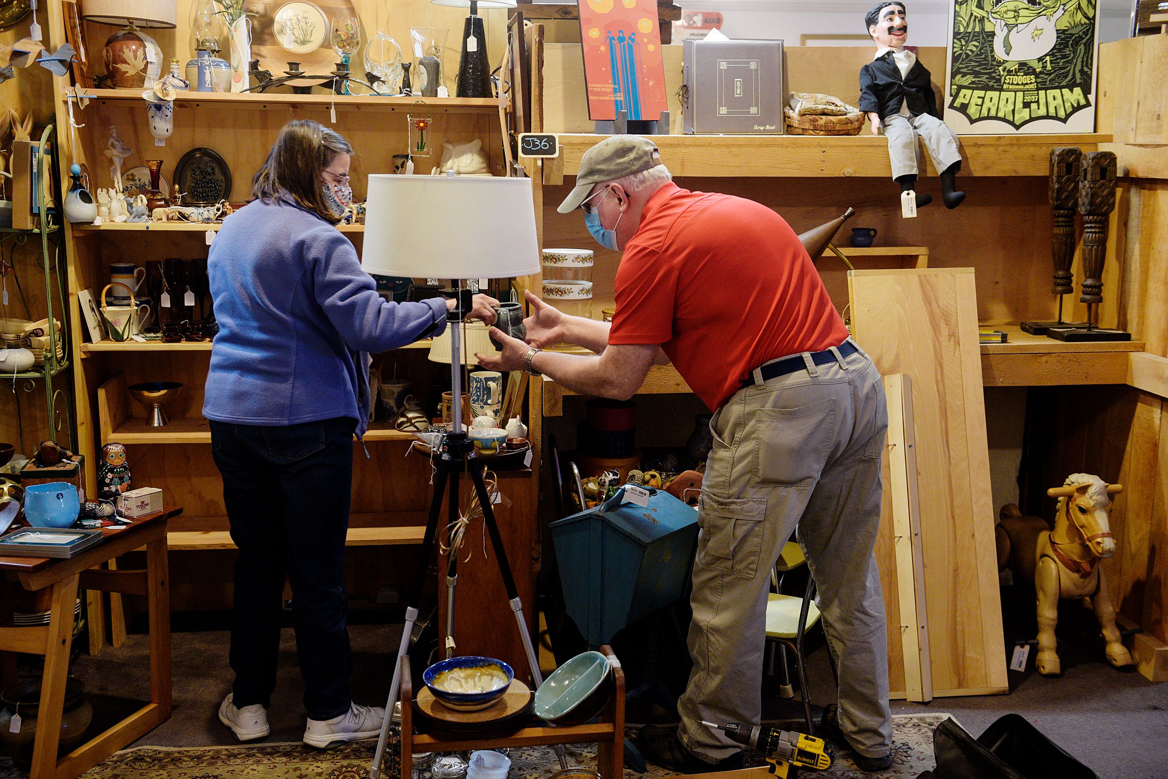 Anne Nix, of Waterbury, Vt., left, and her husband Mike move items from her consignment booth at Consign and Design in West Lebanon, N.H., so they can add new shelves on Friday, March 26, 2021. Nix started to sell items at the store three years ago "as a way to get rid of excess stuff I'd collected over the years that I just wasn't using," she said. (Valley News - James M. Patterson) Copyright Valley News. May not be reprinted or used online without permission. Send requests to permission@vnews.com.
