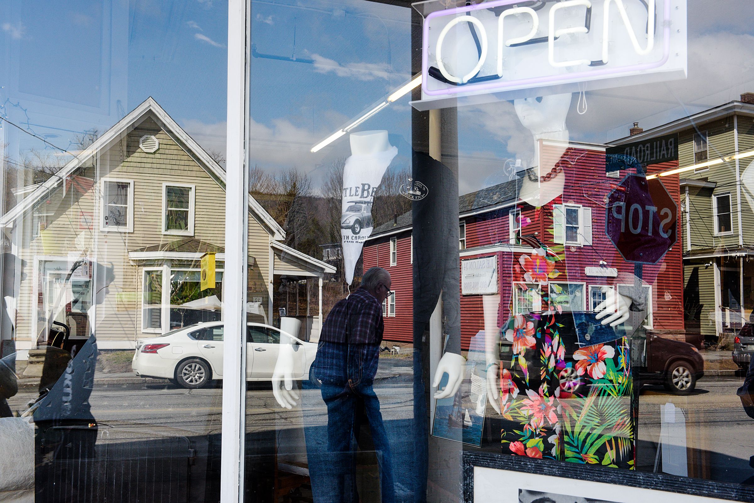 Buildings on Main Street in West Lebanon, N.H., are reflected in the windows of Consign and Design, a three-floor second-hand store, Friday, March 30, 2021. (Valley News - James M. Patterson) Copyright Valley News. May not be reprinted or used online without permission. Send requests to permission@vnews.com.