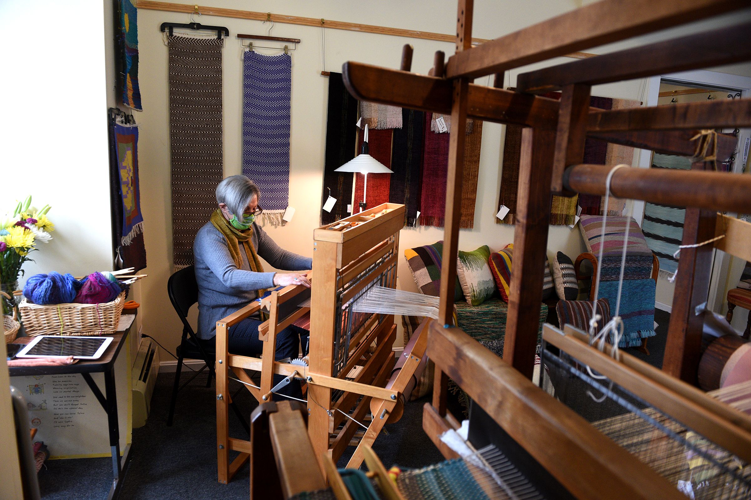 Vassie Sinopoulos works on one of her looms at her studio in Woodstock, Vt., on April 2, 2021. Sinopoulos sometimes uses recycled fabric in her pieces. ( Valley News - Jennifer Hauck) Copyright Valley News. May not be reprinted or used online without permission. Send requests to permission@vnews.com.