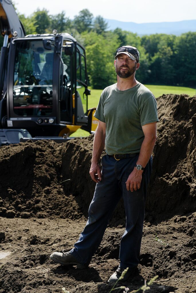 Ben Canonica, of Chelsea, started operating equipment growing up  on a farm in Massachusetts. He now does land management, stone work, builds trails and restores rivers with his business Canonica works on a septic system at a job site in Tunbridge, Vt., Friday, June 25, 2021. Canonica Farm and Forest Services. (Valley News - James M. Patterson) Copyright Valley News. May not be reprinted or used online without permission. Send requests to permission@vnews.com.