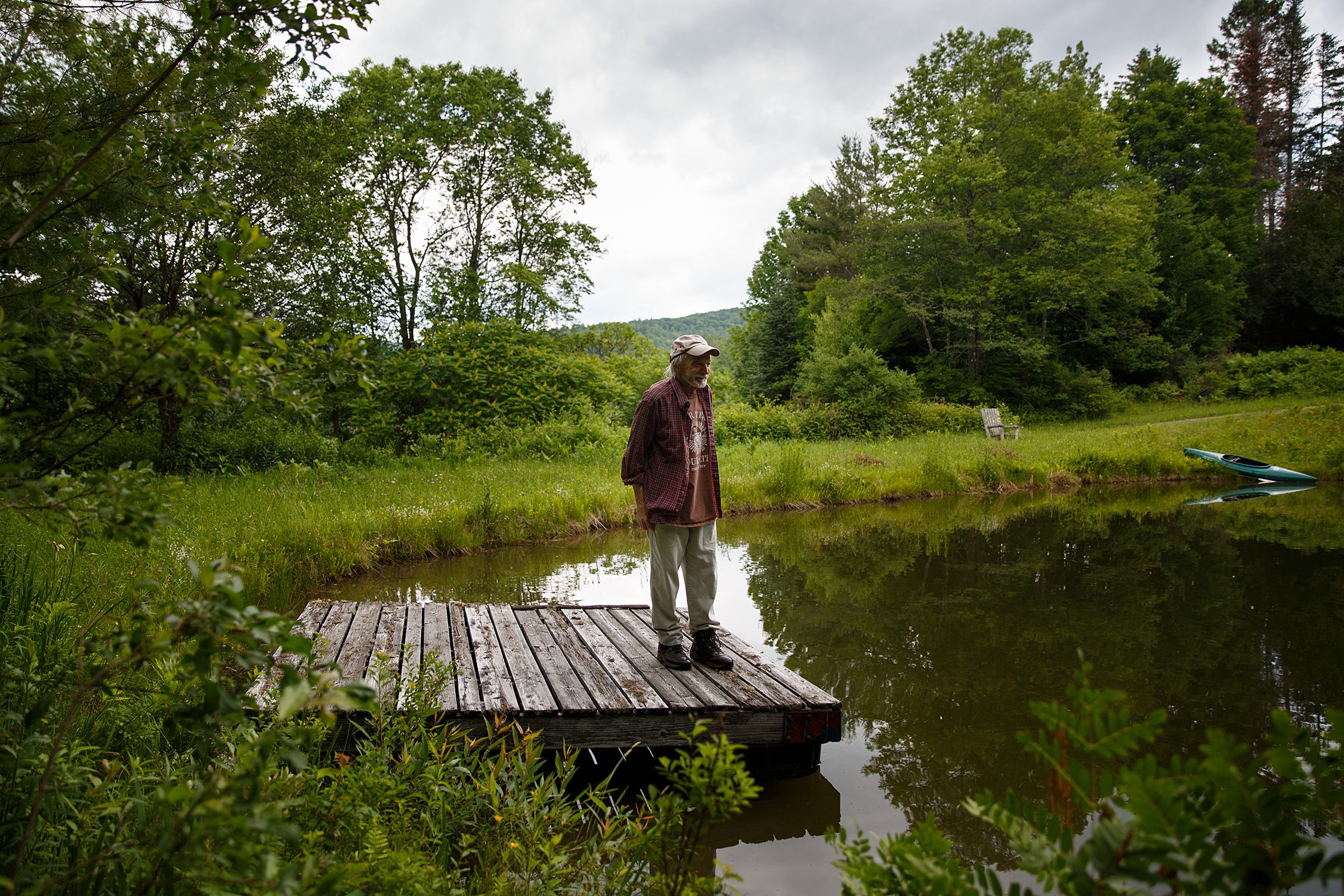 Tim Matson stands on the dock of the pond at his home in Strafford, Vt., on Monday, June 28, 2021. Matson designed the pond in the 1970s and swims in it every day in the summer. (Valley News / Report For America - Alex Driehaus) Copyright Valley News. May not be reprinted or used online without permission. Send requests to permission@vnews.com.