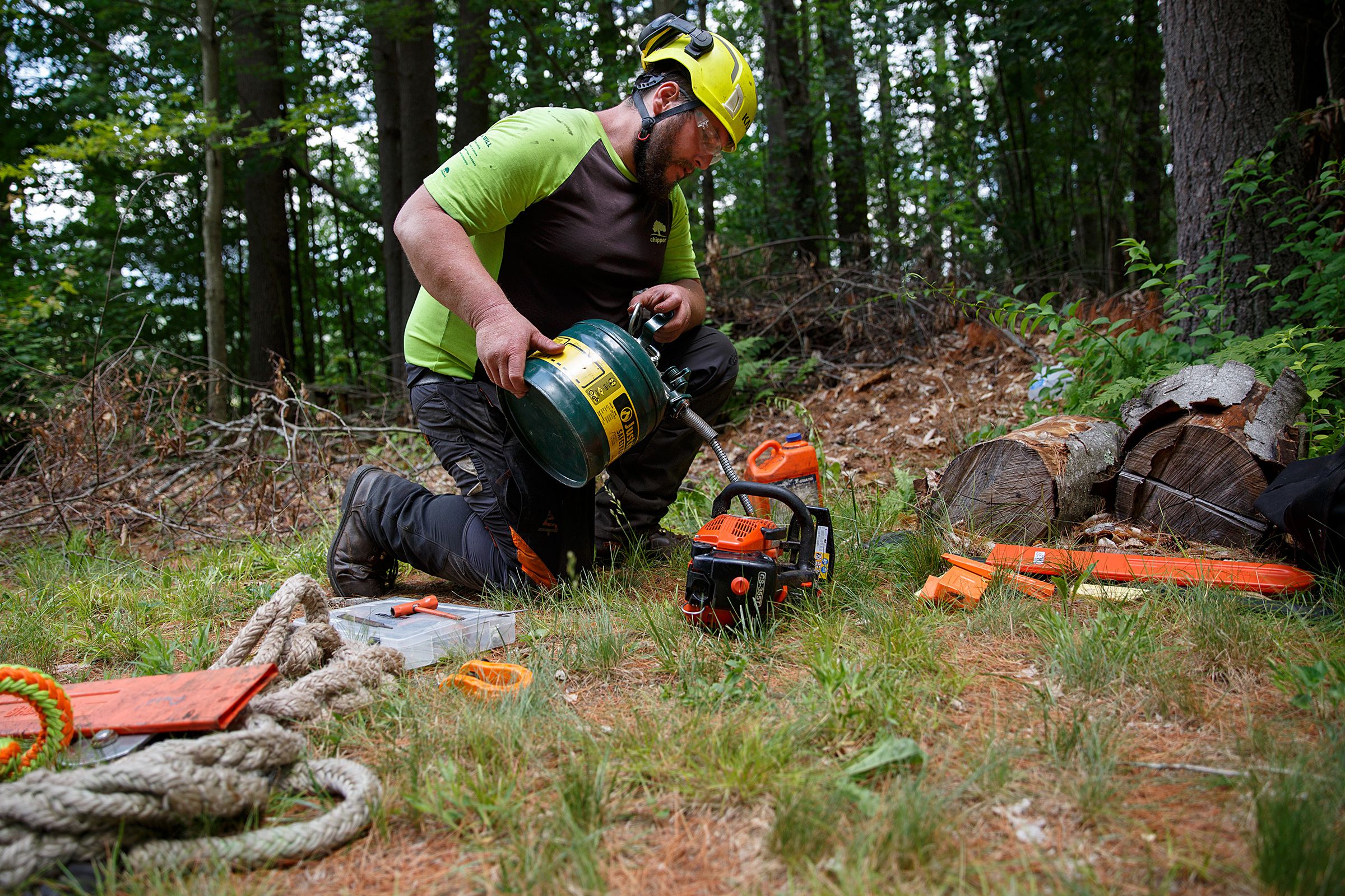 Matt Gray, of Goshen, N.H., refills a chainsaw with gas during a Chippers, Inc. tree removal job at a home in Hanover, N.H., on Wednesday, June 30, 2021. (Valley News / Report For America - Alex Driehaus) Copyright Valley News. May not be reprinted or used online without permission. Send requests to permission@vnews.com.