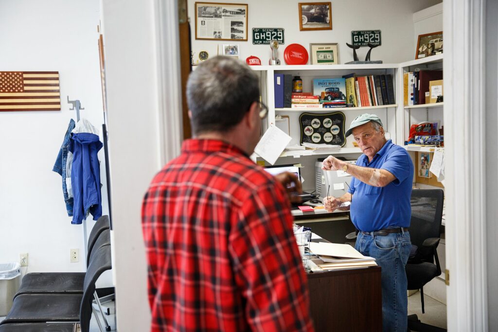 Bob LaCroix, right, talks to his son, Robbie LaCroix, in his office at Shaker Valley Auto in Enfield, N.H., on Friday, Oct. 1, 2021. Robbie was 12 when his parents started the business, and Bob says he would get off of the school bus and come straight to work. (Valley News / Report For America - Alex Driehaus) Copyright Valley News. May not be reprinted or used online without permission. Send requests to permission@vnews.com.