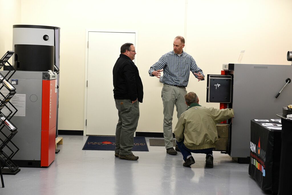 Scott Nichols of Tarm Biomass, shows a wood boiler to Joe Raleigh, of Swanton, Vt., left, and his father-in-law Edward Belisle, of Highgate Center, Vt. Raleigh made the trip to the Orford, N.H., location to pick up a refactory kit for his boiler. He spent some time looking over a newer model on Nov. 17, 2016.(Valley News - Jennifer Hauck) Copyright Valley News. May not be reprinted or used online without permission. Send requests to permission@vnews.com.