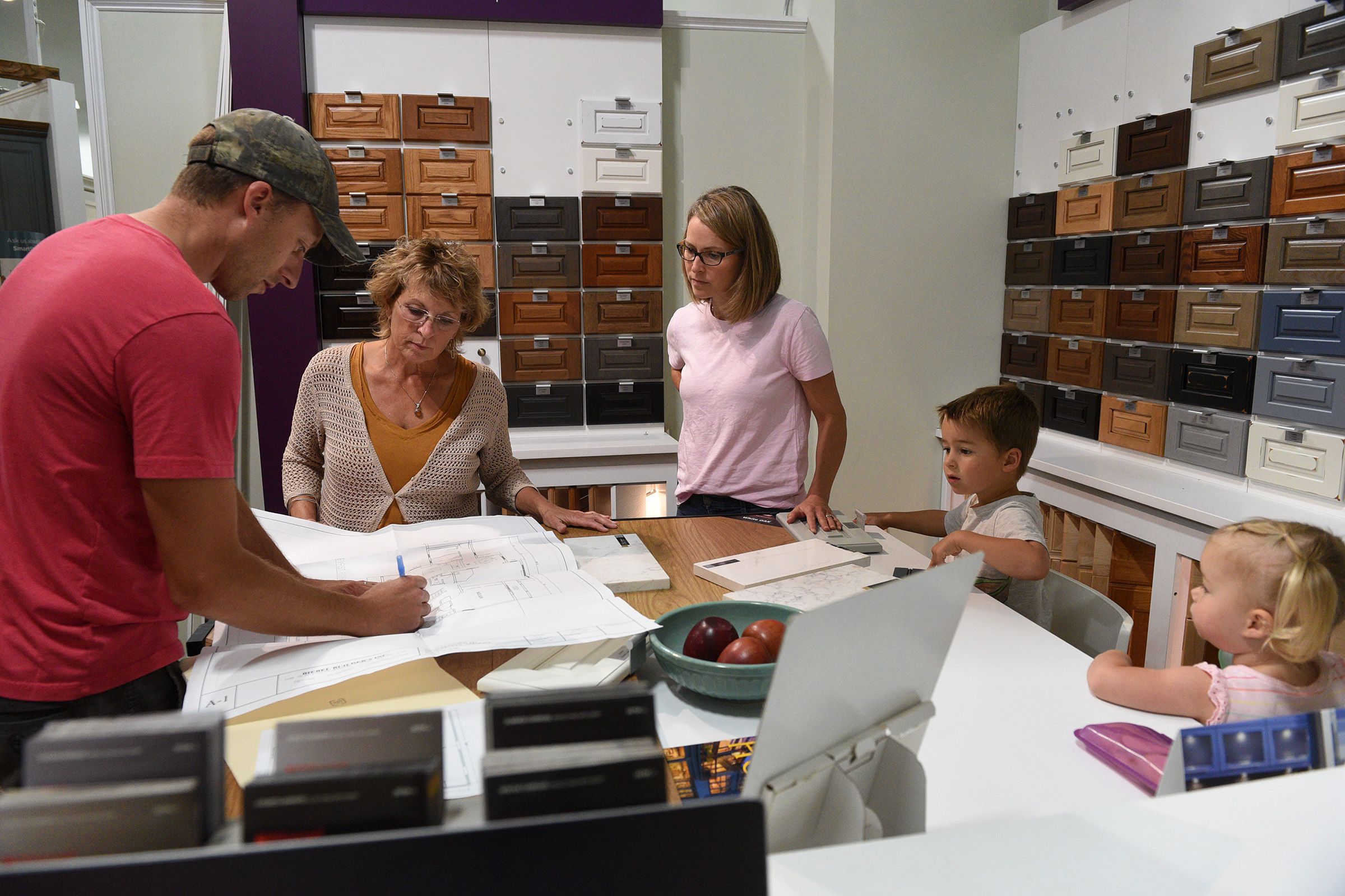 Stephanie and Tim Biebel, along with their children Oliver, 4, and Eden, 2, of Windsor, Vt., look over plans for their kitchen with kitchen designer Sheila Varnese at LaValley Building Supply in West Lebanon, N.H., on Wednesday, June 29, 2022. ( Valley News - Jennifer Hauck) Copyright Valley News. May not be reprinted or used online without permission. Send requests to permission@vnews.com.