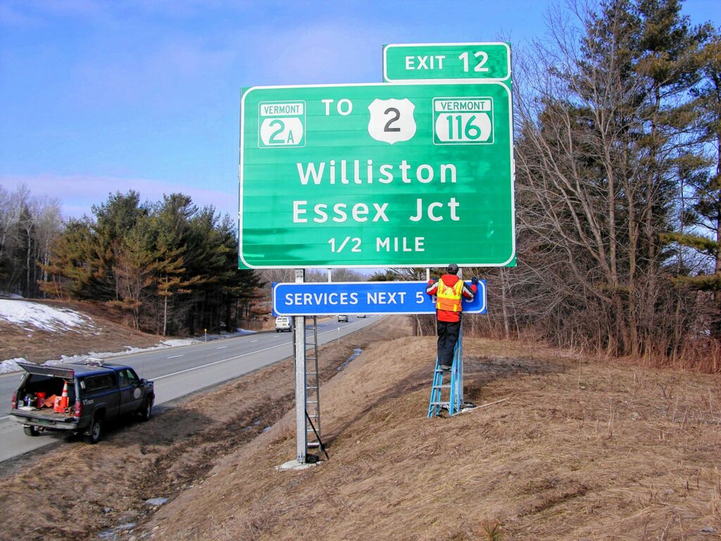 Work on an exit sign along Interstate 89 in 2011. (Courtesy Vermont Agency of Transportation)