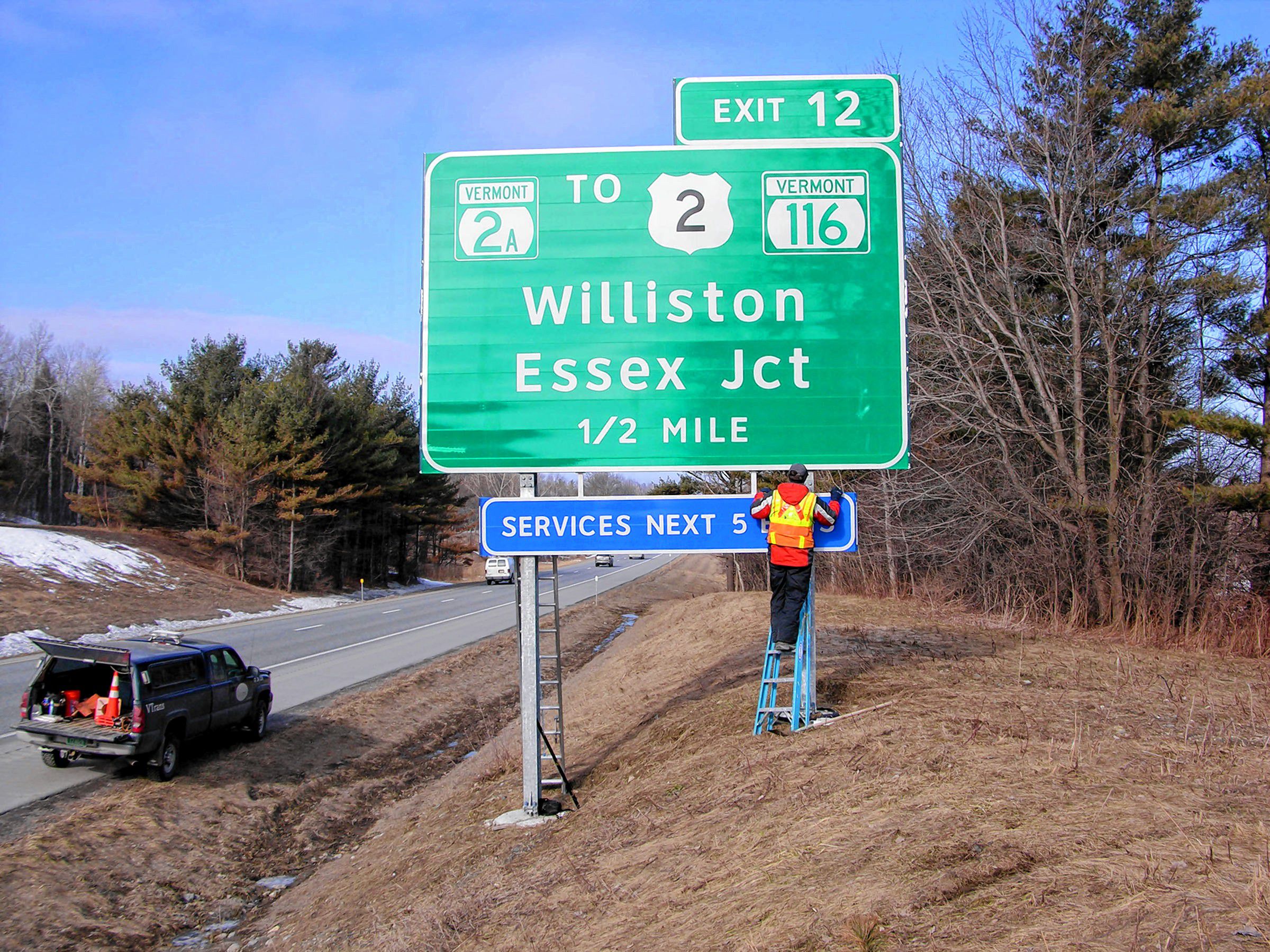 Work on an exit sign along Interstate 89 in 2011. (Courtesy Vermont Agency of Transportation)