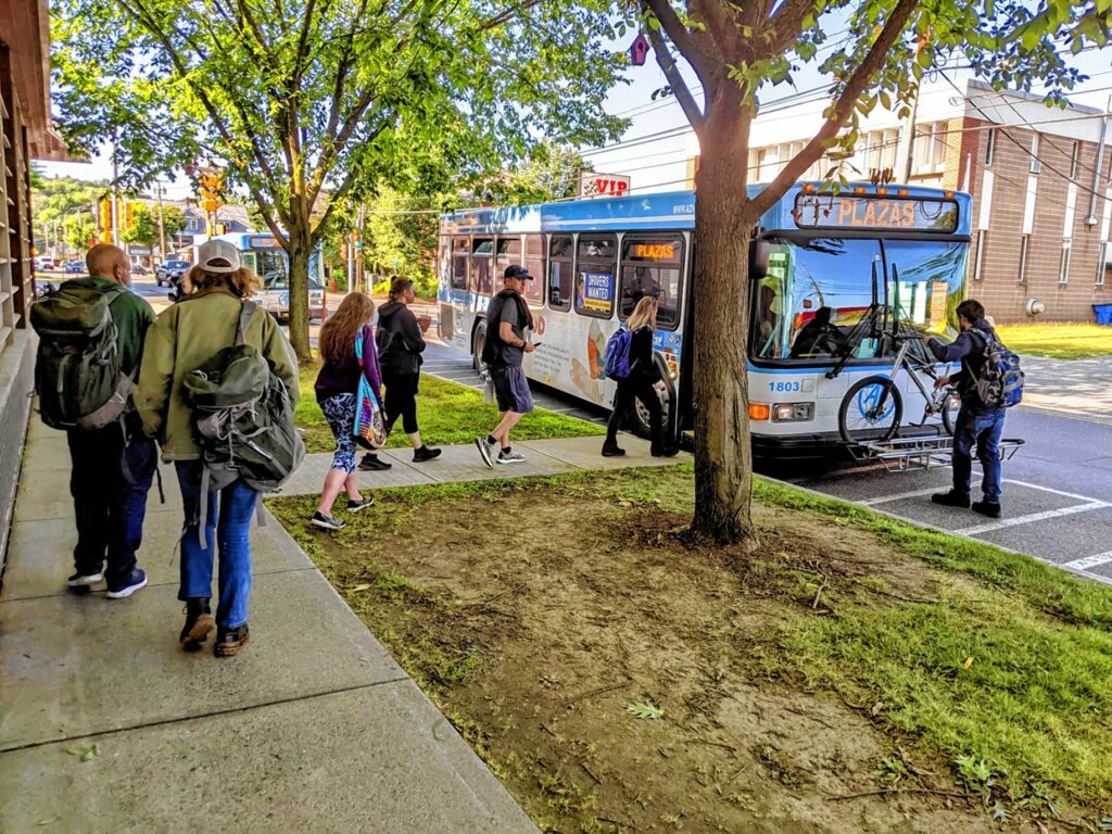 Passengers board an Advance Transit bus on a July morning from a stop outside the Kilton Public Library in West Lebanon. (Courtesy Advance Transit)