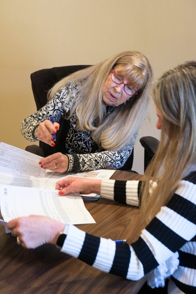 Real estate agent Doreen Wyman, of Granite Northland Associates, prepares a listing with Shelli Vanier, co-owner of Upper Valley Home Sales, in Canaan, N.H., on Tuesday, Jan. 10, 2023. Wyman is the vice president of Upper Valley Board of Realtors. (Valley News - James M. Patterson) Copyright Valley News. May not be reprinted or used online without permission. Send requests to permission@vnews.com.