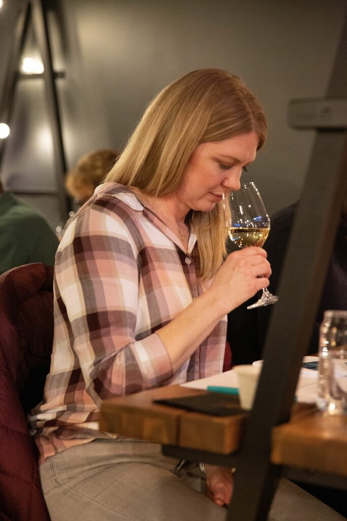 Carrie Grandt, of Wilder, Vt., smells a glass of wine before tasting it during a Wine 101 class at Putnam’s vine/yard in White River Junction, Vt., on Thursday, March 23, 2023. (Valley News / Report For America - Alex Driehaus) Copyright Valley News. May not be reprinted or used online without permission. Send requests to permission@vnews.com.