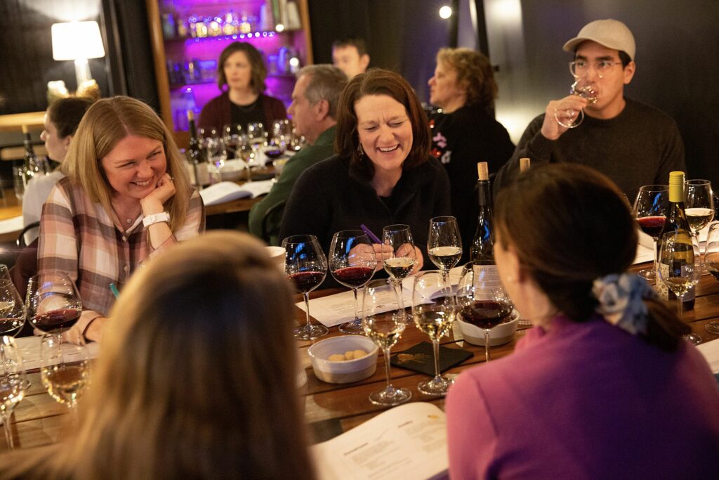 Clockwise from top left, Carrie Grandt, of Wilder, Vt., Caitlin Barthelmes, of Wilder, Jimmy Huynh, of White River Junction, Vt., Emily Owens, of Wilder, and Natalie Looney, of White River Junction, participate in a Wine 101 class at Putnam’s vine/yard in White River Junction on Thursday, March 23, 2023. The wine bar offers “Wine School” and “Vine School” classes multiple times a month, and owner Kelsey Rush said the spaces have been selling out quickly. (Valley News / Report For America - Alex Driehaus) Copyright Valley News. May not be reprinted or used online without permission. Send requests to permission@vnews.com.